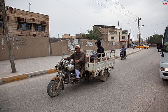 Irak, Karbala. Motocykl trojkolowy jadacy ulica w polnocnej czesci miasta.